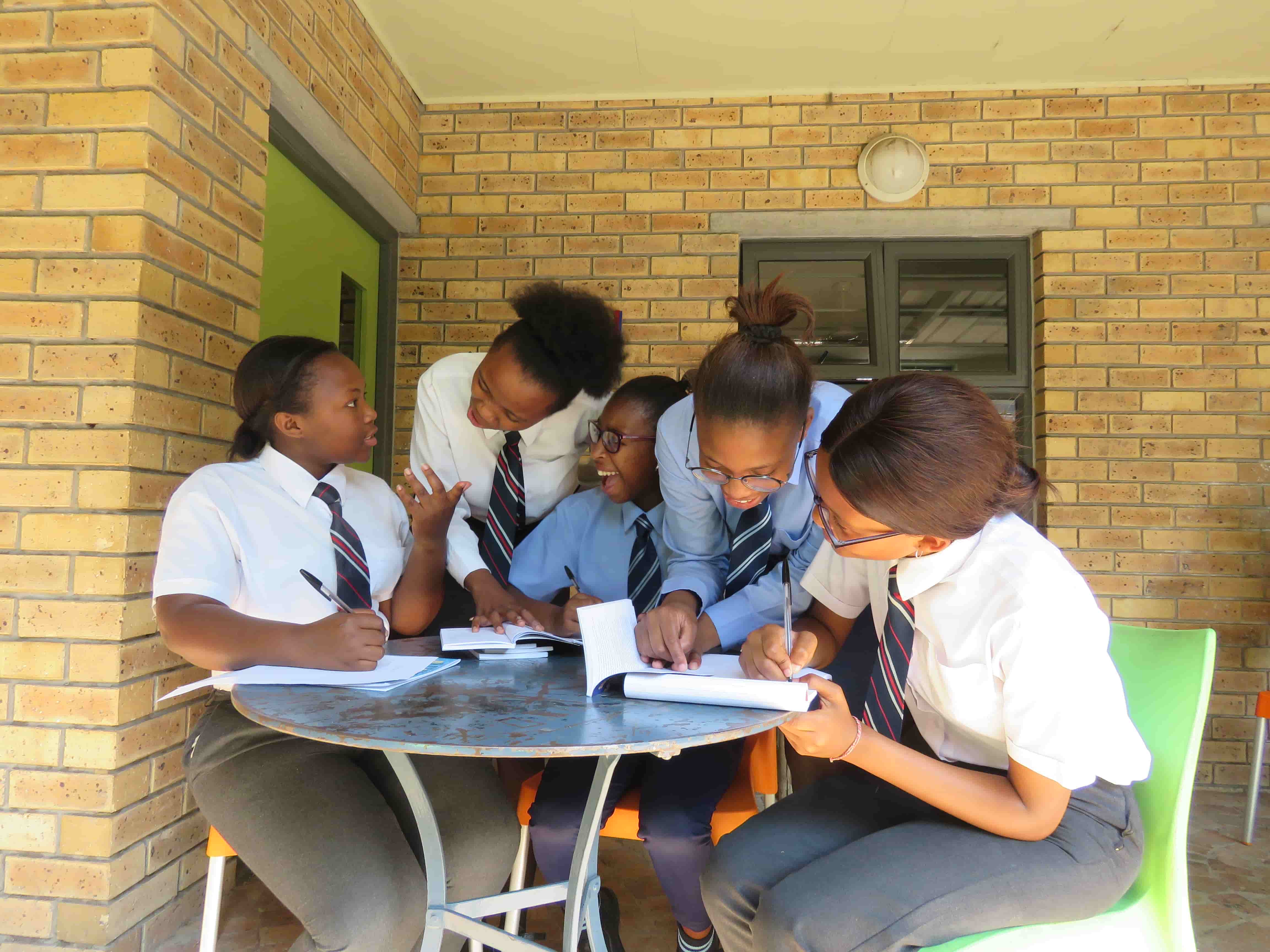 A group of learners collaborating on reading and writing activities